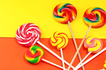 Lollipop on yellow and orange background. Lolly candyの写真素材