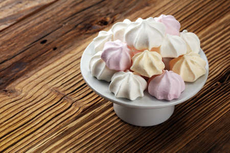 Meringue. Crispy white and pink twisted meringue. Concept love of sweetの写真素材