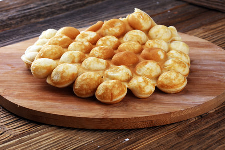 Hong Kong style egg waffle on wooden board. bubble waffle. street food waffles