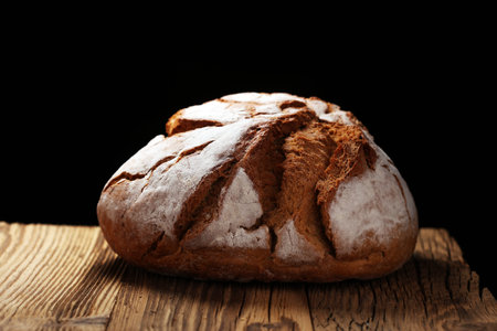 freshly baked bread on rustic wooden background