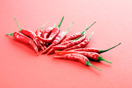 red hot bird chili pepper flat lay on red background