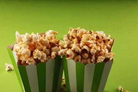 Cinema concept with popcorn in green white bagの写真素材