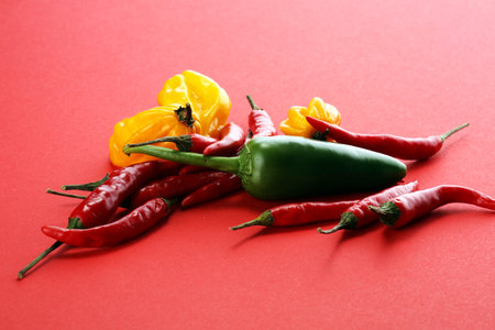 red hot bird chili pepper flat lay on red background