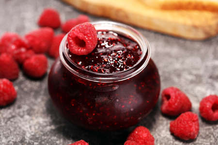 raspberry jam with fresh raspberries. marmalade in jar.の写真素材