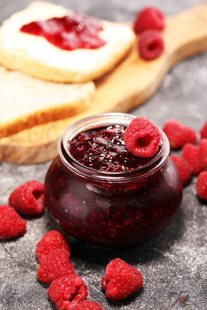 raspberry jam with fresh raspberries. marmalade in jar.