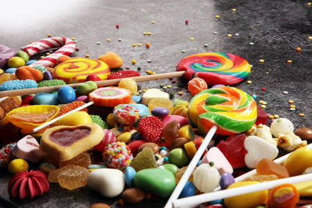 candies with jelly and sugar. colorful array of different childs sweets and treatsの写真素材