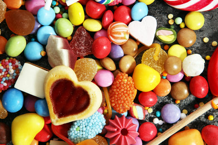 candies with jelly and sugar. colorful array of different childs sweets and treatsの写真素材