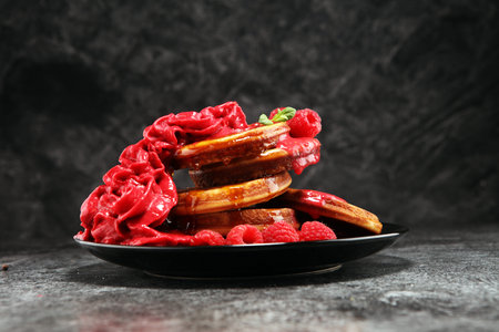 Pancakes with berries and maple syrup on rustic table.の写真素材