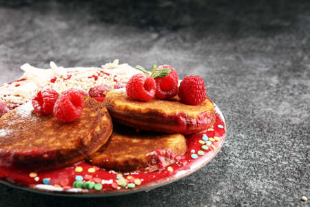Pancakes with berries and maple syrup on rustic table.の写真素材
