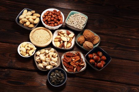nuts composition on rustic table with walnut and peanut