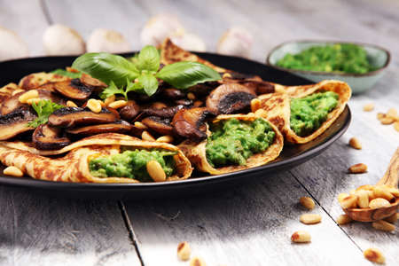 Savory Homemade Mushroom and Spinach Crepes with Cheese and avocadoの写真素材