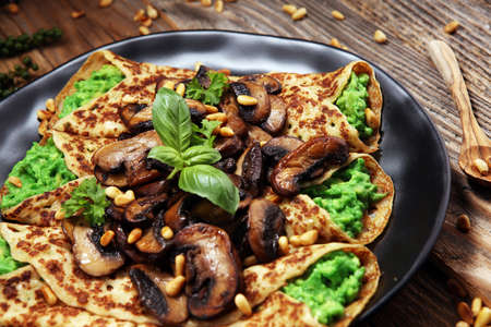 Savory Homemade Mushroom and Spinach Crepes with Cheese and avocadoの写真素材