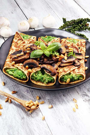 Savory Homemade Mushroom and Spinach Crepes with Cheese and avocadoの写真素材