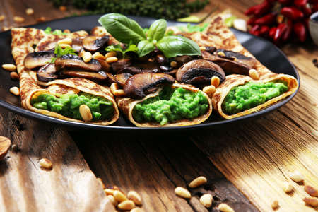 Savory Homemade Mushroom and Spinach Crepes with Cheese and avocadoの写真素材