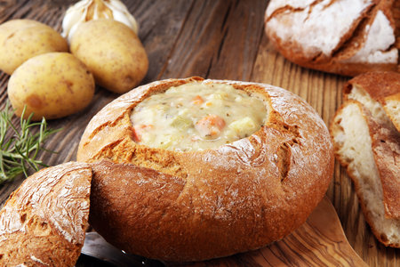 Homemade potato cream soup, served in bread bowlの写真素材