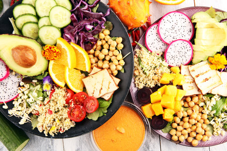 grilled tofu and dragon fruit buddha bowl with vegetable and humus.