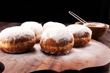 German donuts with jam and icing sugar. Carnival powdered sugar raised donuts.の写真素材