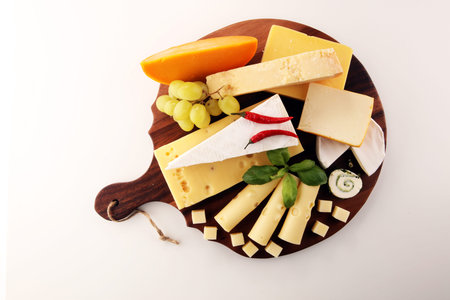 Cheese plate served with grapes, various cheese on a platter.