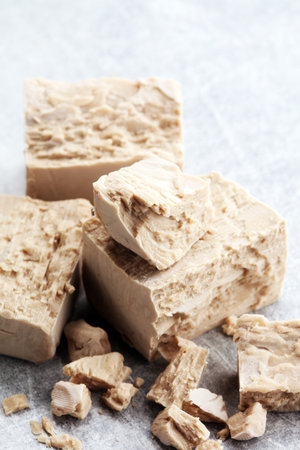 Dry yeast crumbled and yeast block for baking.