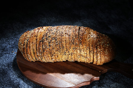 freshly baked bread on wooden board. cutted bread for bakery concept