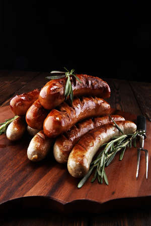 Grilled sausages with spices on a wooden table - Home-made Pork Sausages for barbecueの写真素材