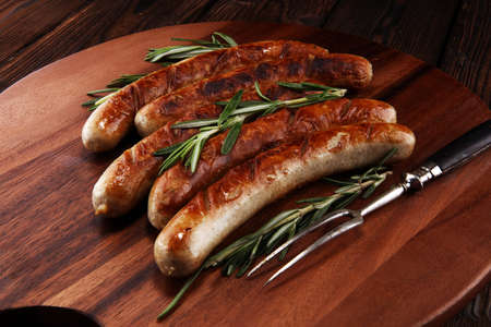 Grilled sausages with spices on a wooden table - Home-made Pork Sausages for barbecueの写真素材