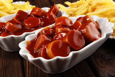 currywurst with fries. traditional german food with sausages and curry and friesの写真素材
