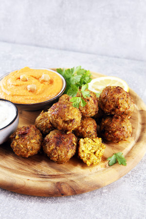 Traditional homemade hummus, falafel and chickpea served with spices on table. Jewish Cuisine with falafelの写真素材