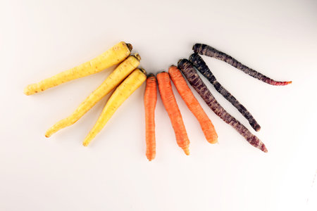 pile of carrots. Crate of mixed fresh harvested colorful carrot on tableの写真素材