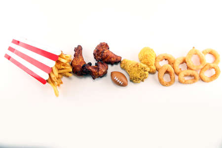 chicken wings, fries and onion rings for football on a table. Great for Bowl football Gameの写真素材