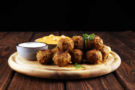 Traditional homemade hummus, falafel and chickpea served with spices on table. Jewish Cuisine with falafelの写真素材