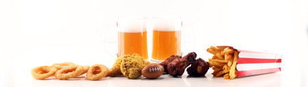 Chips, salty snacks, football and Beer on a table. Great for Bowl Game projects.の写真素材