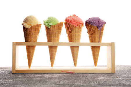 Set of ice cream scoops of different colors and flavours with berries, nuts and fruits and vanilla 