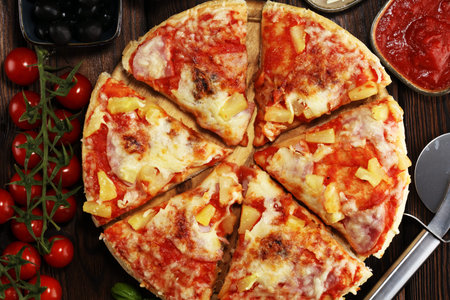 Delicious pizza with pineapple, ham slice, bacon slice, mozzarella cheese, pizza sauce on rustic...