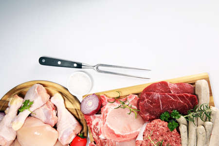 raw meat. Different types of raw pork meat, chicken and beef with spices and herbs and sausagesの写真素材
