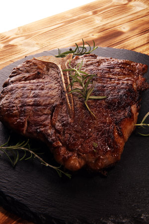 Grilled T-bone steak on stone plate. bbq grill bone steak set