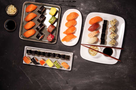 close up of sashimi sushi set with chopsticks and soy - sushi roll with salmon and sushi roll with smoked eel, selective focus.の写真素材