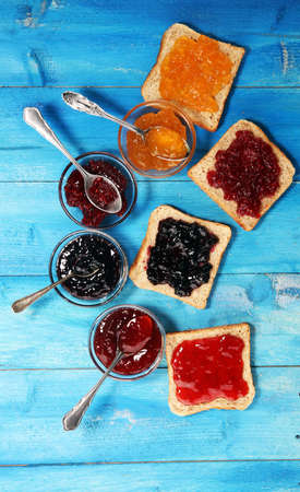 assortment of jams, seasonal berries, plums, mint and fruits with strawberry and currantsの写真素材