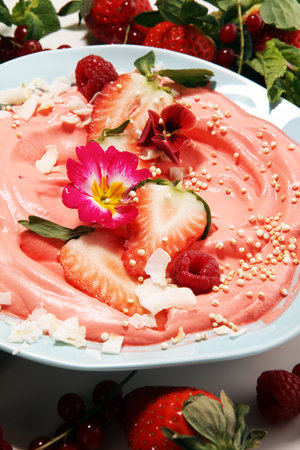 Healthy homemade raw vegan banana and berry ice cream (icecream, nicecream) topped with organic...