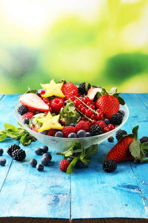 salad with fresh fruits and berries. healthy spring fruit salad on tableの写真素材