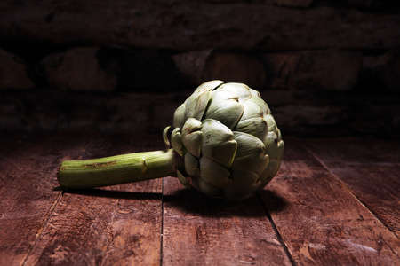 artichokes on old rustic background. fresh organic artichoke flowerの写真素材