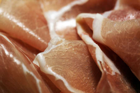 Italian prosciutto crudo or jamon with rosemary. Raw ham on wooden backgroundの写真素材