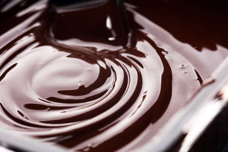 Melting chocolate, melted delicious chocolate for praline icing confectionery. swirl of chocolateの写真素材
