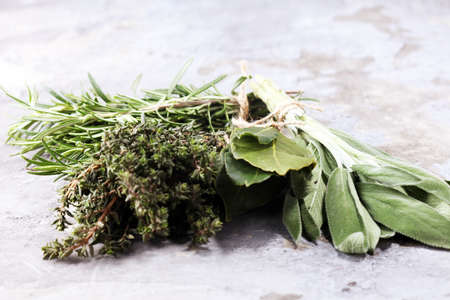 Homegrown and aromatic herbs on rustic background.Set of culinary herbs. Green growing sage, oregano, thyme, basil, mint and oregano.の写真素材