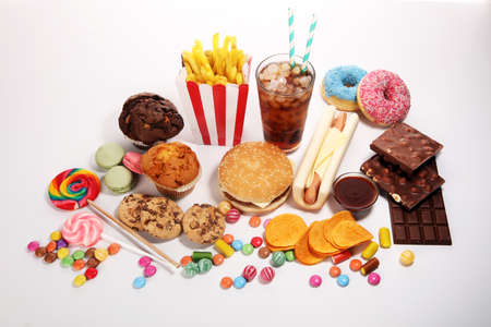 Unhealthy products. food bad for figure, skin, heart and teeth. Assortment of fast carbohydrates food with candyの写真素材