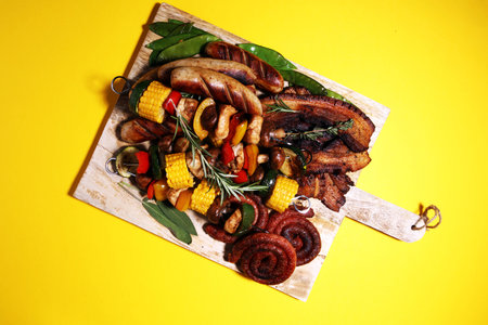 Assorted delicious grilled meat and skewer with vegetable and herbs on rustic table