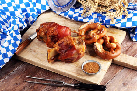 Traditional German cuisine, Schweinshaxe roasted ham hock. pretzels Bavarian specialties. Oktoberfest backgroundの写真素材