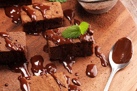 Cake chocolate brownies on wooden background with mint on rustic backgroundの写真素材