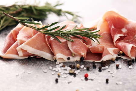 Italian prosciutto crudo or jamon with rosemary. Raw ham appetizerの写真素材