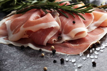 Italian prosciutto crudo or jamon with rosemary. Raw ham appetizerの写真素材